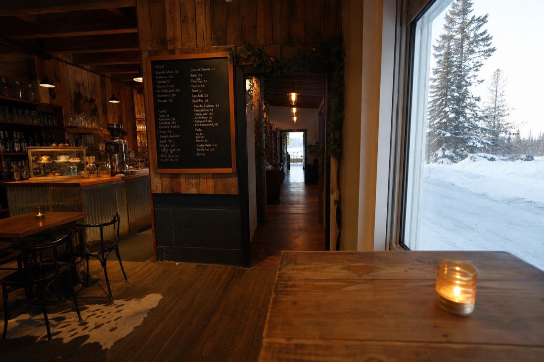 Menu board and warm interior of a small northern cafe with winter light through the window