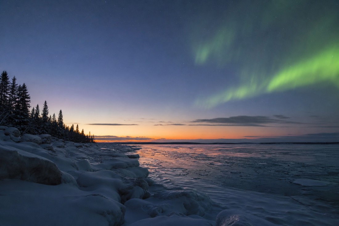 Late evening twilight sky over Great Slave Lake in early spring with the last colour fading behind a low horizon