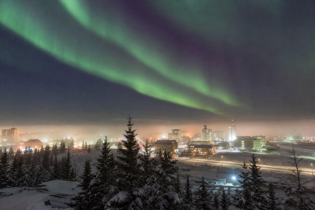 Ice fog hanging over downtown Yellowknife buildings on a deep cold January morning